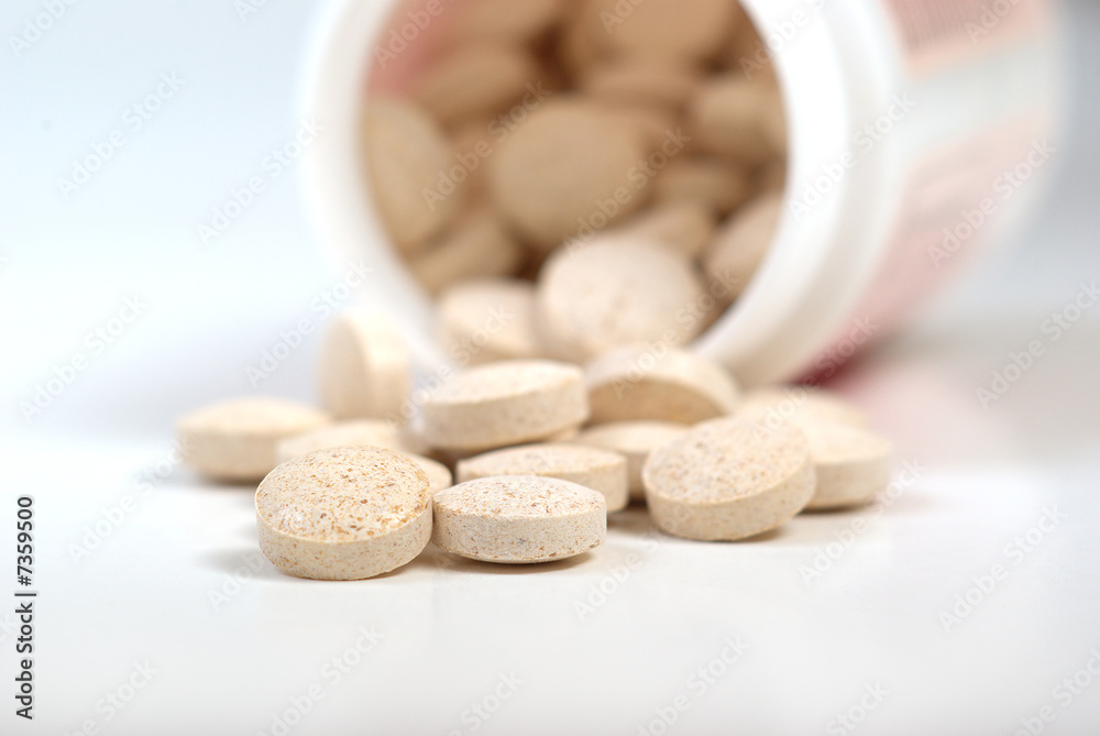 Pills Spilling out of Pill Bottle closeup Pills Spilling out of Pill Bottle closeup