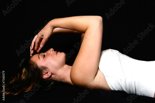 brunette in white sequinned bustier, lying down