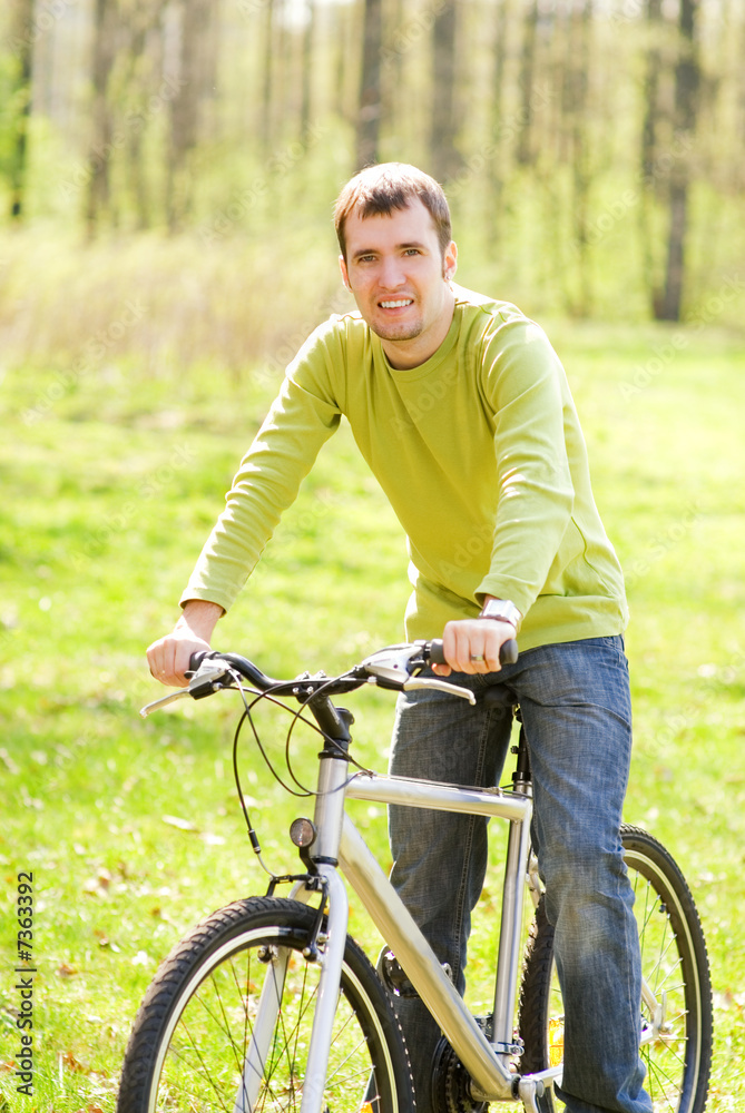 Handsome young man riding a bike