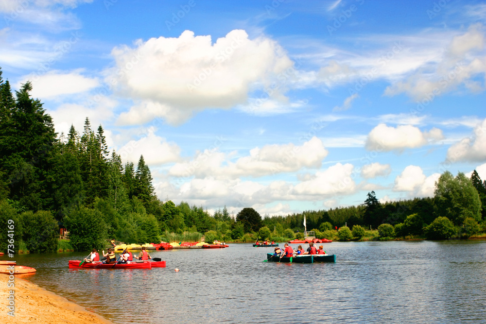 Fototapeta premium Groups of children having fun in canoeing in the lake.