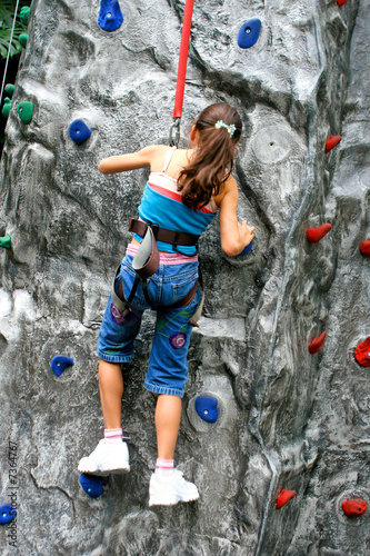 Young girl doing rock climbing 
