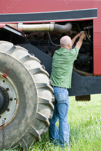 Man changing oil filter on large engine