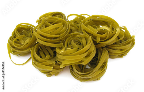Tagliatelle green pasta with spinach isolated on white photo
