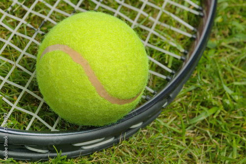 Tennis ball and racket close up