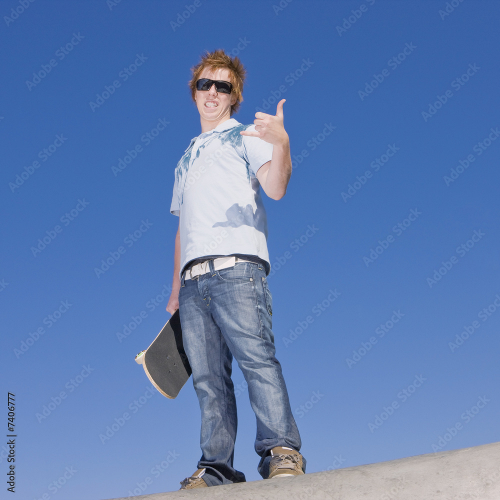 Teen skater atop ramp Teen skater atop ramp