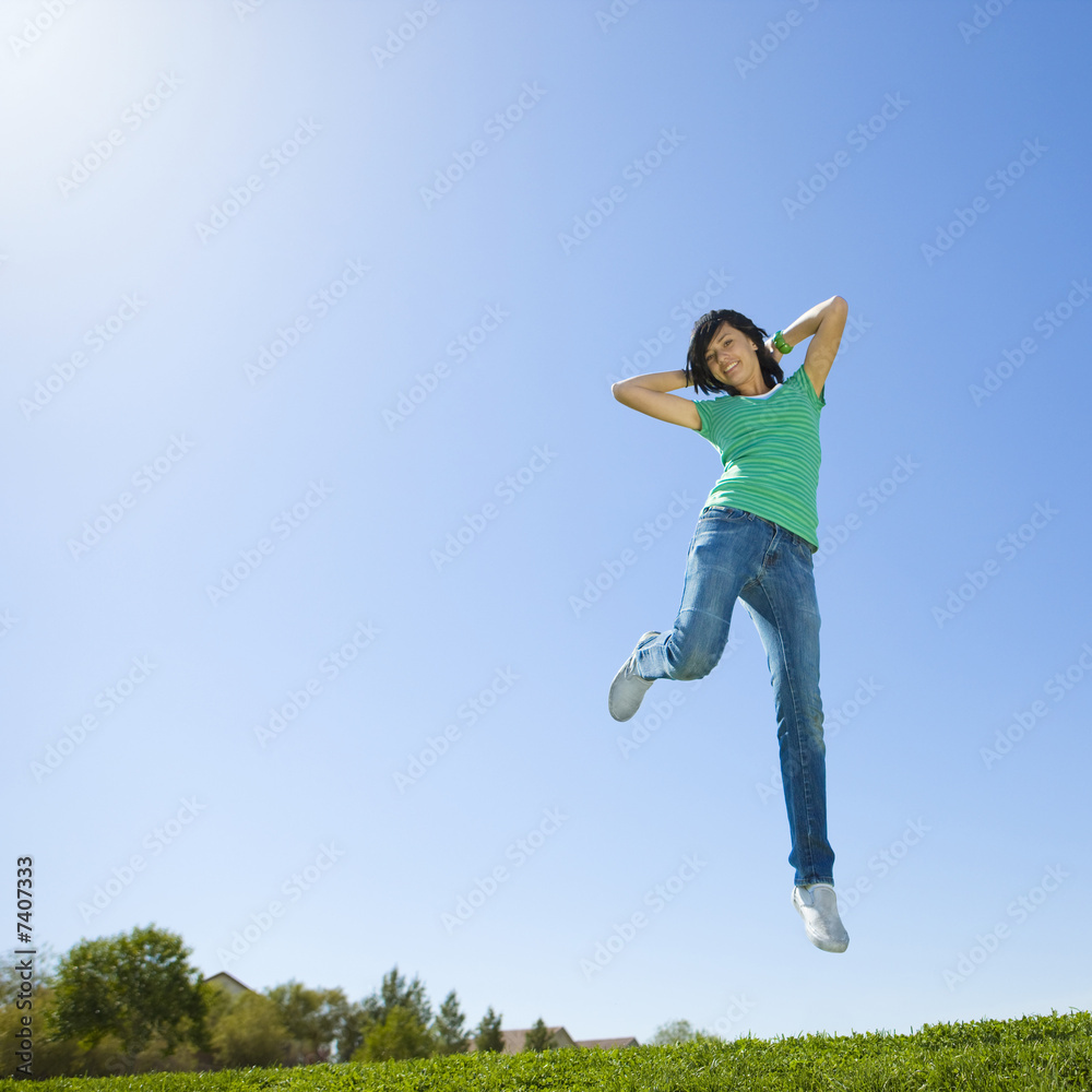Happy teen jumps in air.