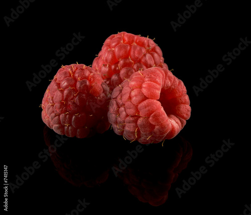 Red Raspberries on a black reflective background