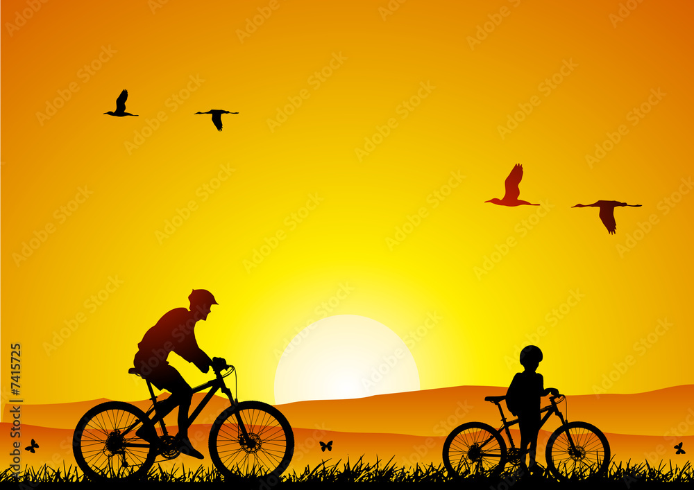 Fototapeta premium Mountain bike at sunset with child