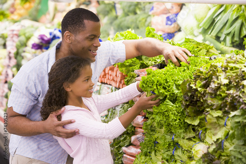 Father and daughter in produce section photo