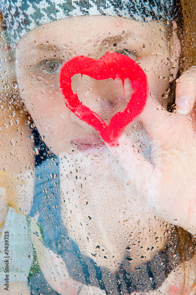 Fototapeta premium girl behind glass after a rain