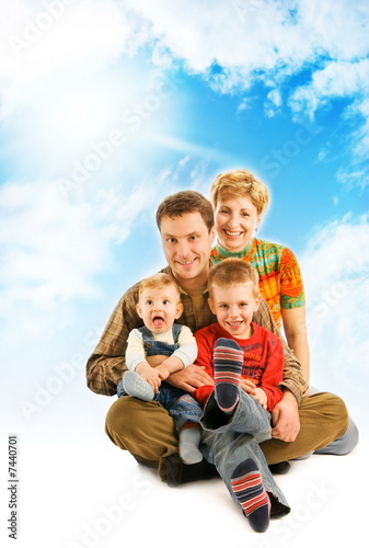 Happy family over blue sky
