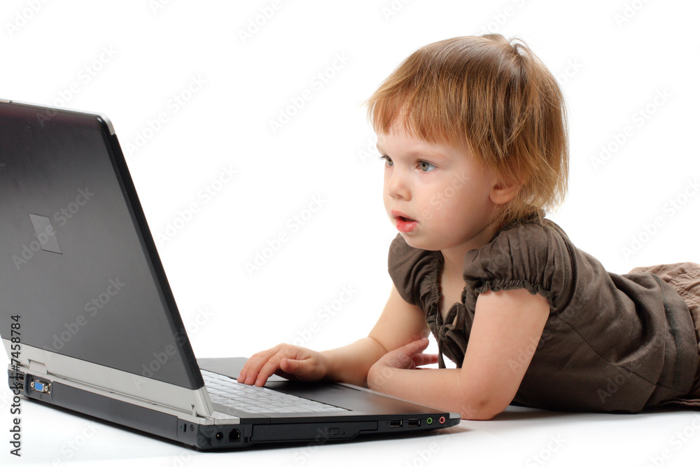 Small girl lieing and learning at notebook Small girl lieing and learning at notebook
