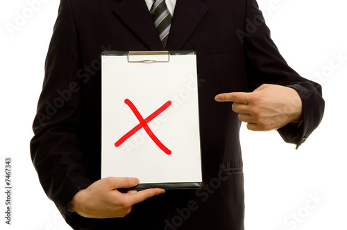 Red X on clipboard in the hand of a businessman