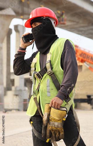 Construction Worker Using A Handheld Transceiver