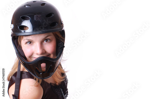 Close-up portrait of blonde girl in black helmet