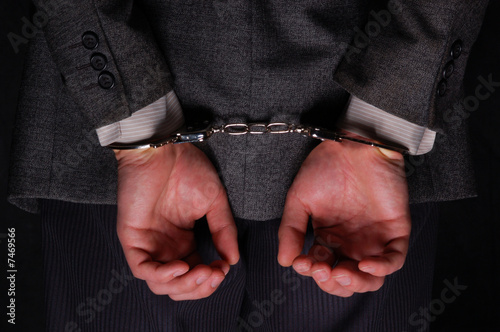 Canvas Print Arrested businessman handcuffed hands at the back