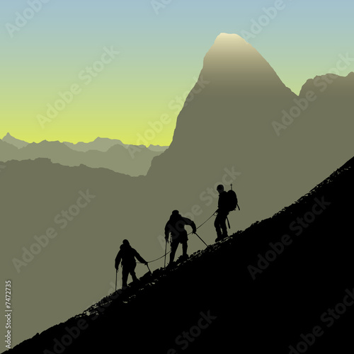 Three climbers descending ridge at sunrise photo