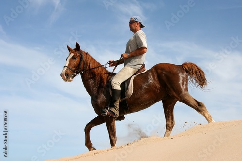 Horse rider on sand dune
