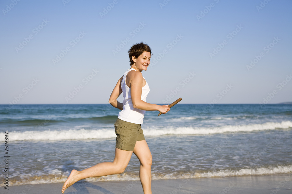 Yong girl running on the beach