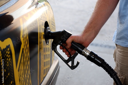 close up of a driver refuelling his vehicle photo