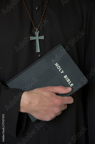 Priest, cross and bible