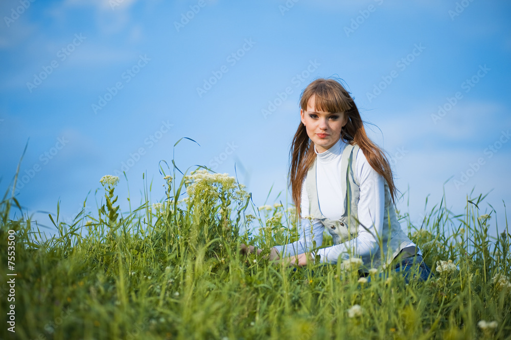 Woman sitting among spring flowers Woman sitting among spring flowers