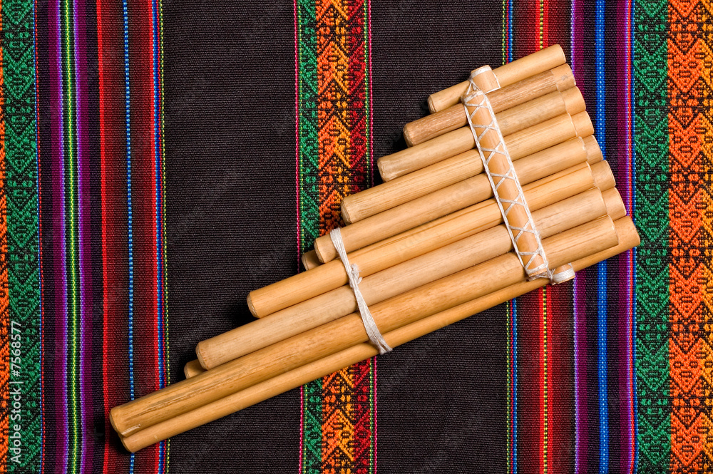 siku, andean wind musical instrument, on traditional tapestry. Photos |  Adobe Stock