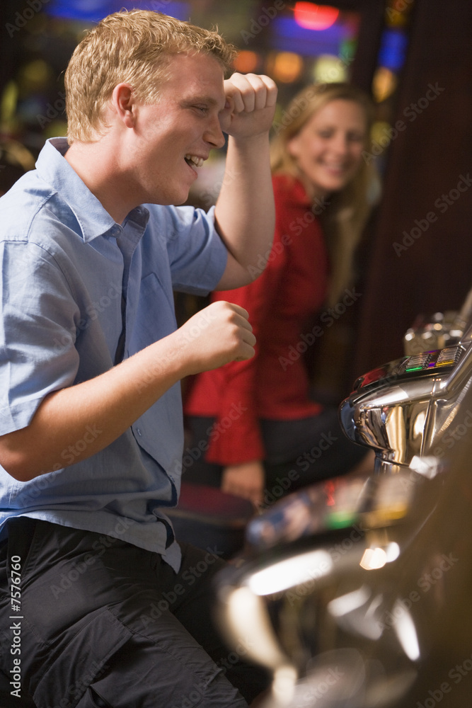 Man celebrating win at slot machine