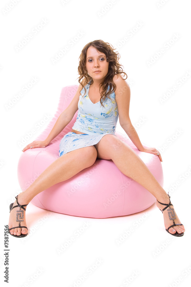 girl sitting on comfortable chair and looking to the camera girl sitting on comfortable chair and looking to the camera