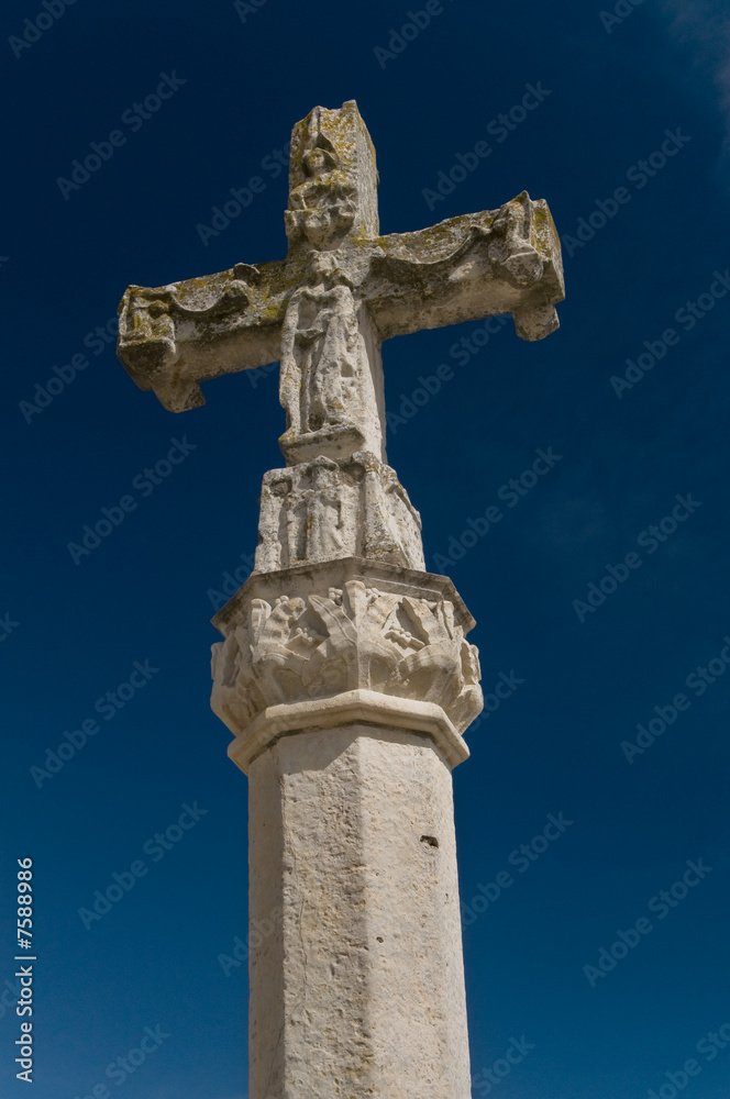 Stone baroque cross in blue sky