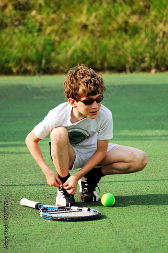 Boy getting ready to play tennis