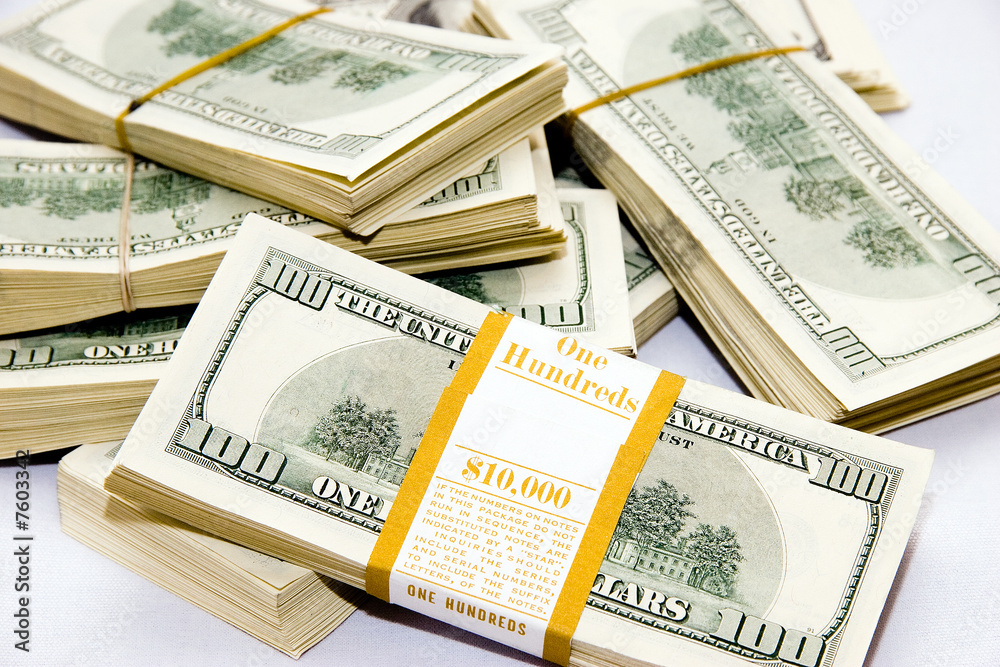 Many big packs of dollars over white sacking Many big packs of dollars over white sacking