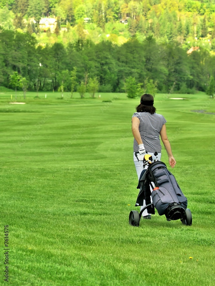 Golfer on golfcourse with golf bag Golfer on golfcourse with golf bag