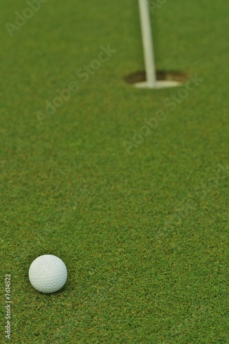 Golf ball in front of the hole