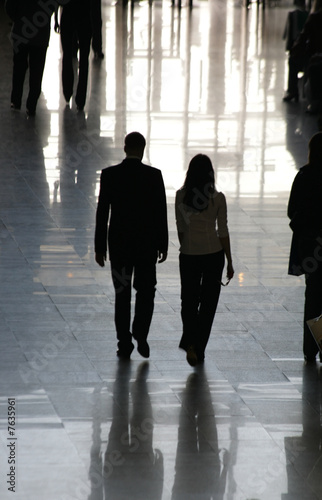 Silhouettes of people in a lobby of office building