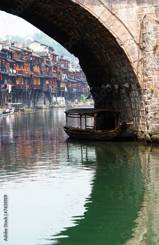 bateau traditionnel chinois et arches d'un ancien pont photo