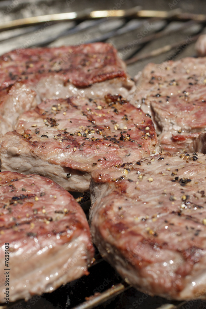 steaks on barbecue grill