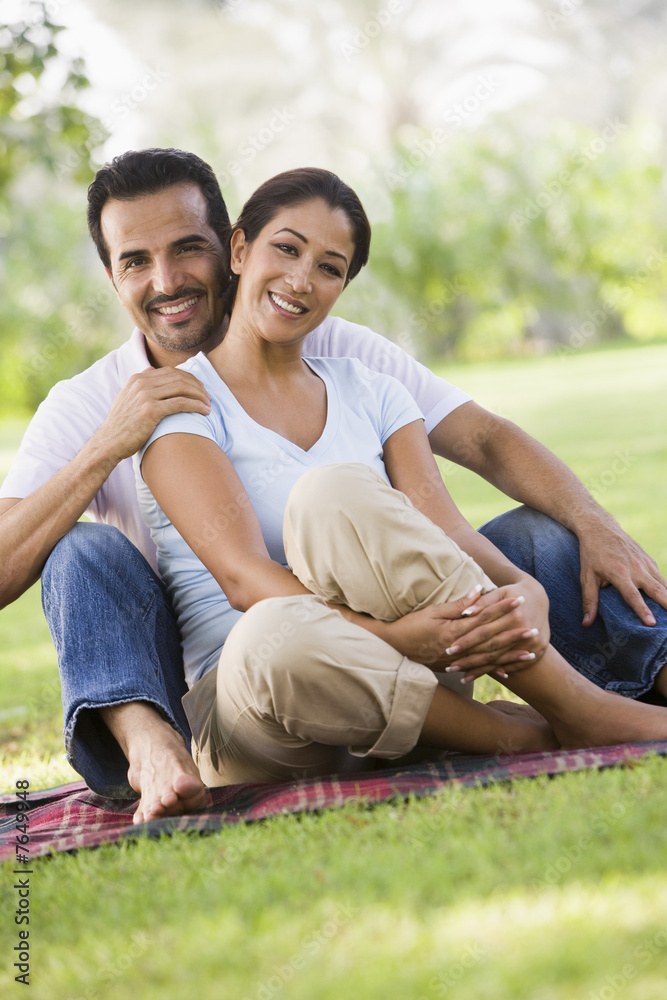 Couple relaxing in park together Couple relaxing in park together
