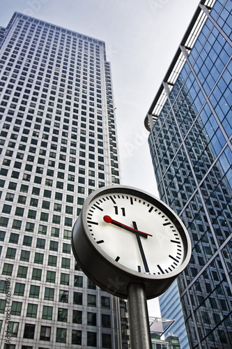 Clock in front of office buildings, London