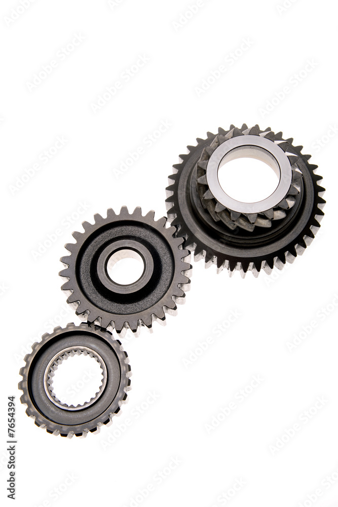 Three gears meshing together over white Three gears meshing together over white