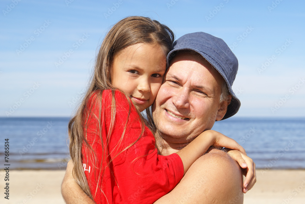 Cheerful father and daughter on a beach