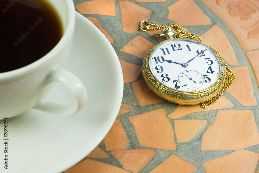 watching time on pocket watch during coffee break watching time on pocket watch during coffee break