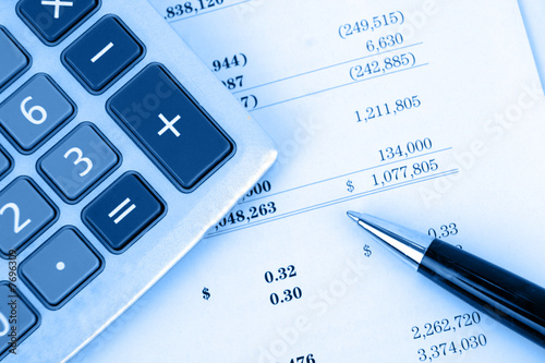 calculator on financial report with blue background