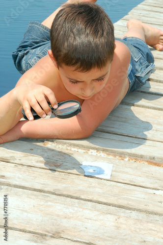 boy with a magnifier photo