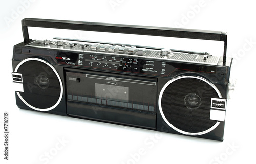 Dirty old 1980s style cassette player radio against a white back