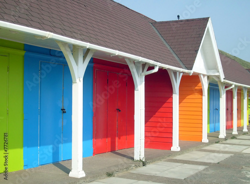 Colorful beach chalets by seaside photo