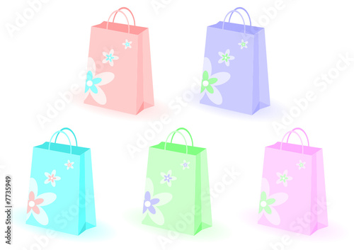 Shopping bags decorated with flowers over white background