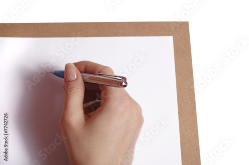 Female hand holding pen over blank card. Isolated on white.