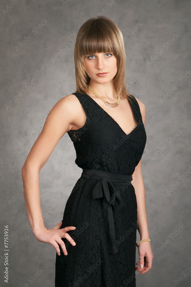 girl in a dress on a grey background girl in a dress on a grey background