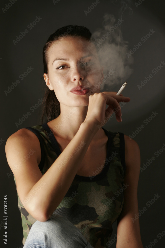 Fototapeta premium Sensual girl in camouflage top smoking